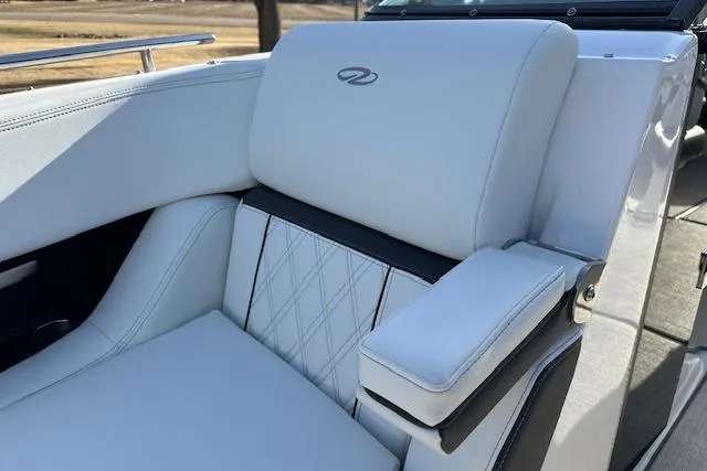 Yacht Photos Pics 2023 Regal 2800 Bowrider boat seat with elegant white upholstery and armrest.