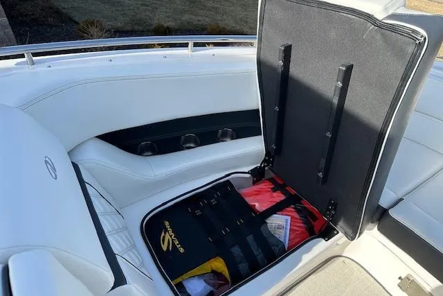  Yacht Photos Pics 2023 Regal 2800 Bowrider boat interior with open storage compartment and white seating.