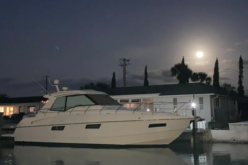 Low Hours!!! Yacht Photos Pics 2012 Cruisers Yachts 48 Cantius docked at night under a full moon.