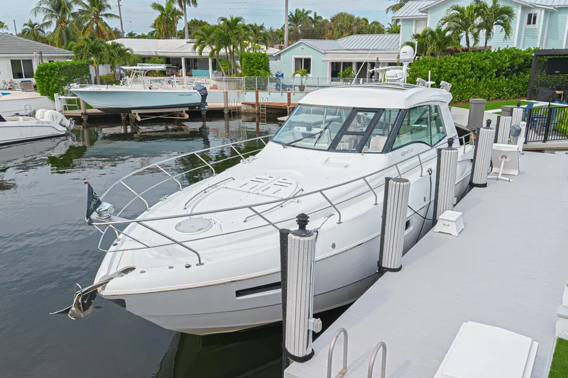 Low Hours!!! Yacht Photos Pics 2012 Cruisers Yachts 48 Cantius docked in a scenic marina setting.