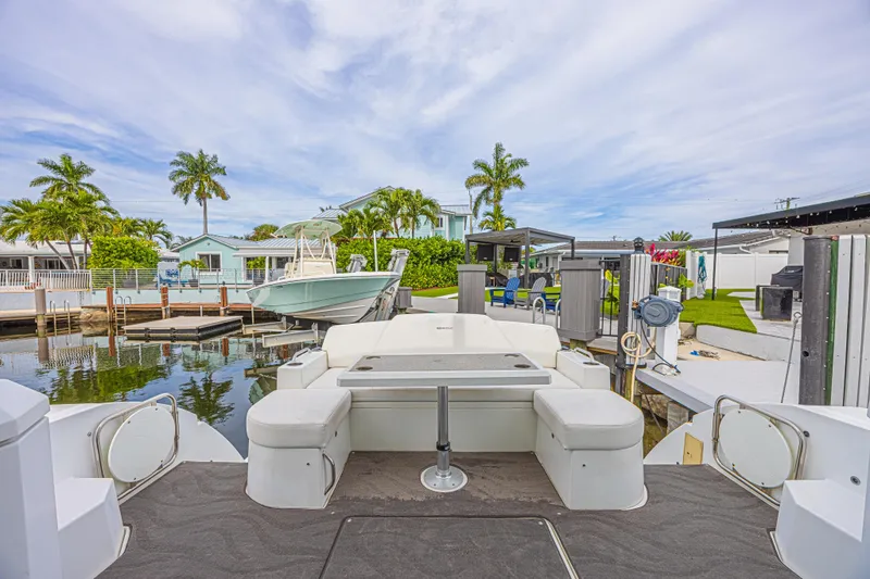 Low Hours!!! Yacht Photos Pics 2012 Cruisers Yachts 48 Cantius docked, featuring spacious seating and scenic waterfront view.