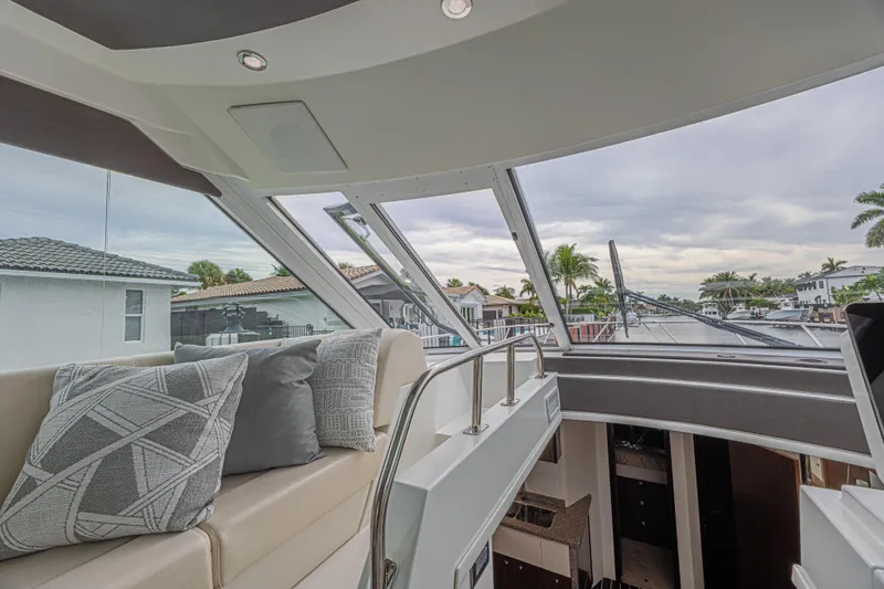 Low Hours!!! Yacht Photos Pics Interior view of 2012 Cruisers Yachts 48 Cantius, featuring plush seating and large windows.