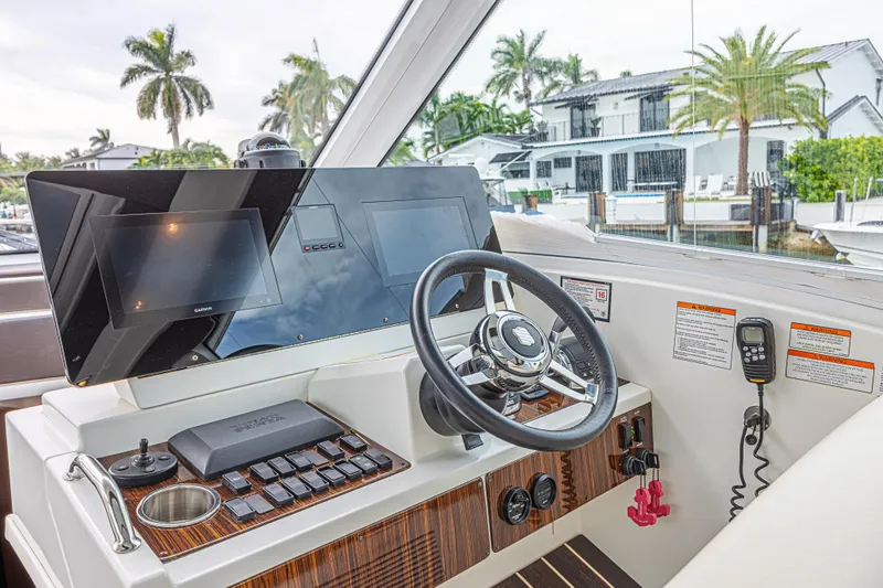 Low Hours!!! Yacht Photos Pics Helm of 2012 Cruisers Yachts 48 Cantius with modern controls and navigation screens.