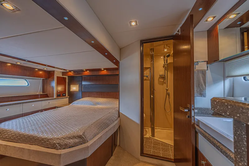 Low Hours!!! Yacht Photos Pics Luxurious 2012 Cruisers Yachts 48 Cantius cabin with elegant wood finishes and ensuite bathroom.
