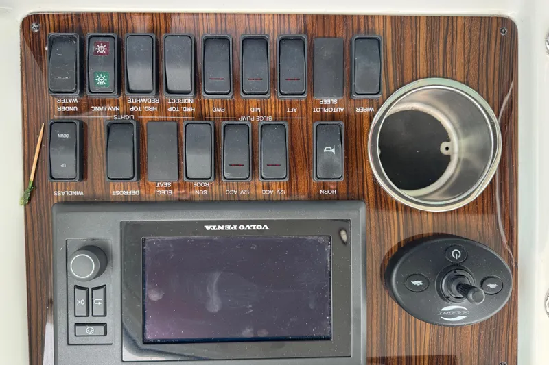 Low Hours!!! Yacht Photos Pics Control panel of 2012 Cruisers Yachts 48 Cantius with switches and Volvo Penta display.