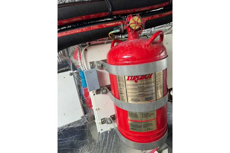 Low Hours!!! Yacht Photos Pics Fire extinguisher in 2012 Cruisers Yachts 48 Cantius engine room, secured with metal straps.