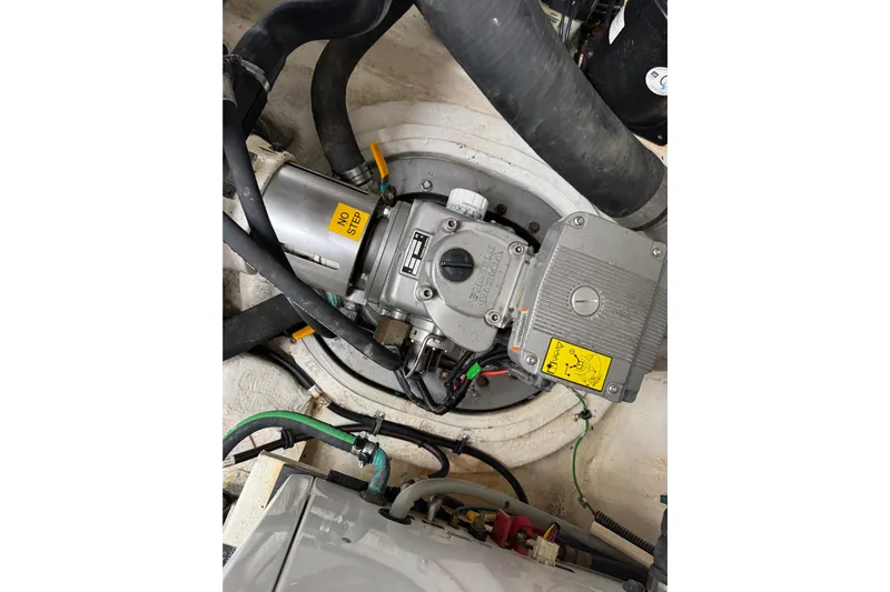 Low Hours!!! Yacht Photos Pics Engine compartment of 2012 Cruisers Yachts 48 Cantius with visible mechanical components.