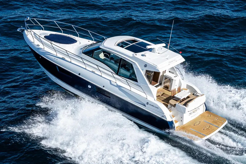 Serenity Yacht Photos Pics 2015 Cruisers Yachts 48 Cantius cruising on open water, showcasing sleek design and luxury.