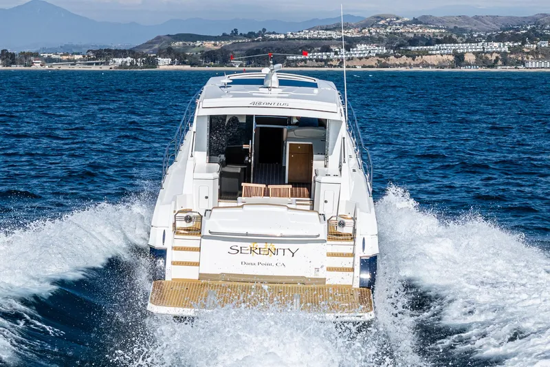 Serenity Yacht Photos Pics 2015 Cruisers Yachts 48 Cantius cruising on open water, rear view.