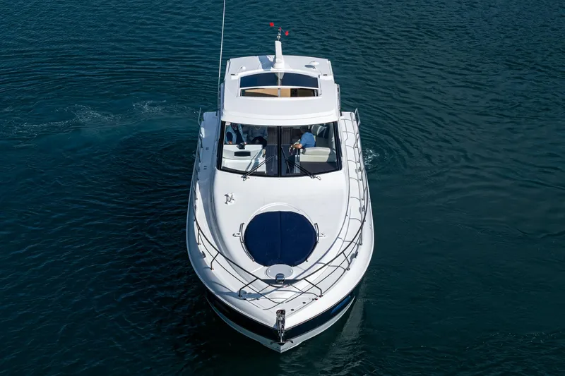Serenity Yacht Photos Pics 2015 Cruisers Yachts 48 Cantius on calm water, aerial view.
