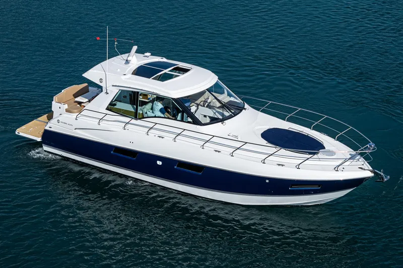 Serenity Yacht Photos Pics 2015 Cruisers Yachts 48 Cantius luxury boat cruising on clear blue water.