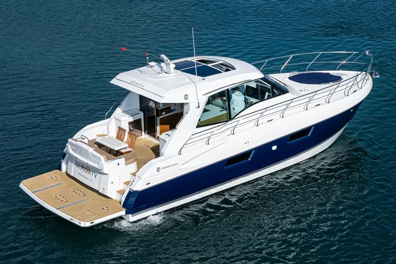 Serenity Yacht Photos Pics 2015 Cruisers Yachts 48 Cantius on water, showcasing sleek design and luxury features.