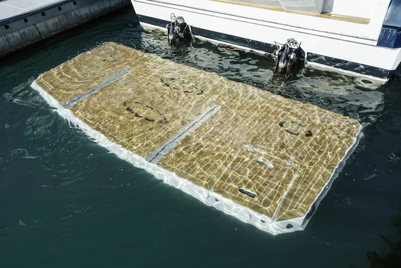 Serenity Yacht Photos Pics 2015 Cruisers Yachts 48 Cantius swim platform submerged in water.