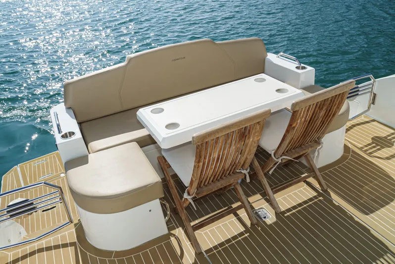 Serenity Yacht Photos Pics Luxury seating area on 2015 Cruisers Yachts 48 Cantius, overlooking serene water.