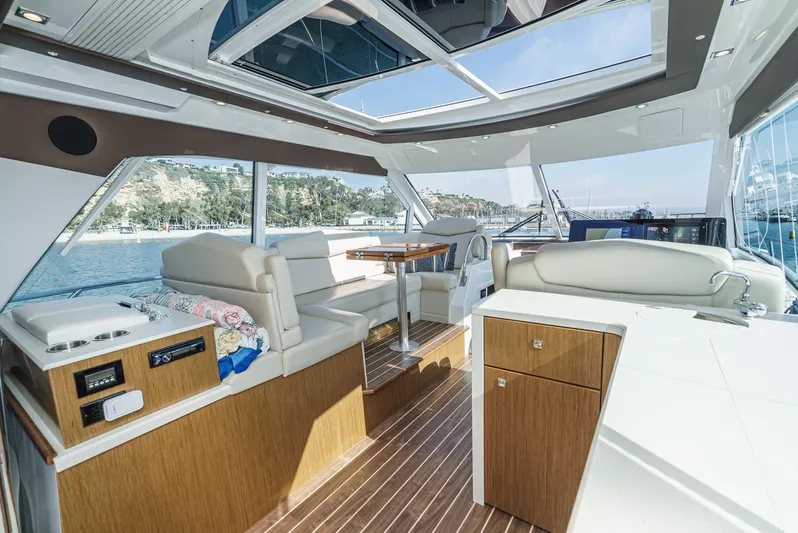 Serenity Yacht Photos Pics Luxurious interior of 2015 Cruisers Yachts 48 Cantius with spacious seating and panoramic windows.