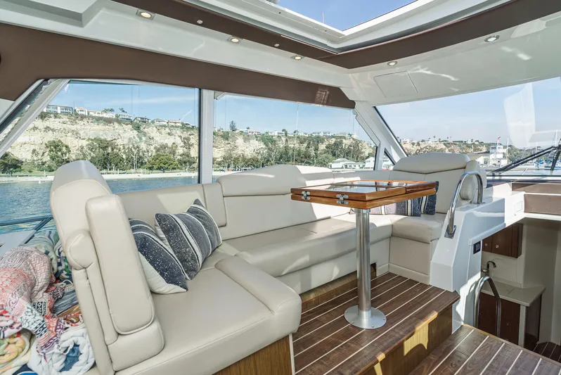 Serenity Yacht Photos Pics Luxurious interior of 2015 Cruisers Yachts 48 Cantius with elegant seating and scenic views.