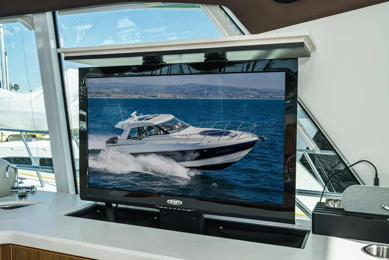 Serenity Yacht Photos Pics 2015 Cruisers Yachts 48 Cantius displayed on a screen inside a yacht.