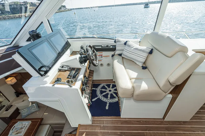 Serenity Yacht Photos Pics 2015 Cruisers Yachts 48 Cantius helm with luxurious seating and modern navigation equipment.