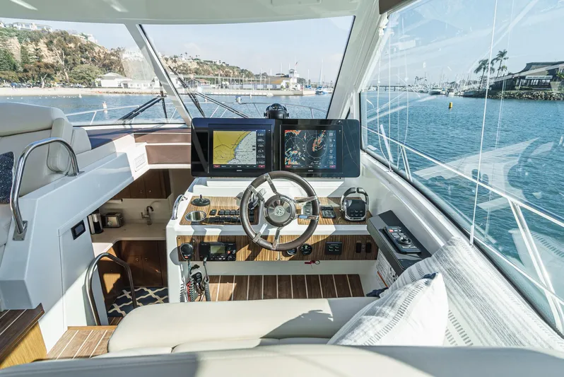 Serenity Yacht Photos Pics Helm of 2015 Cruisers Yachts 48 Cantius with modern navigation displays and steering wheel.