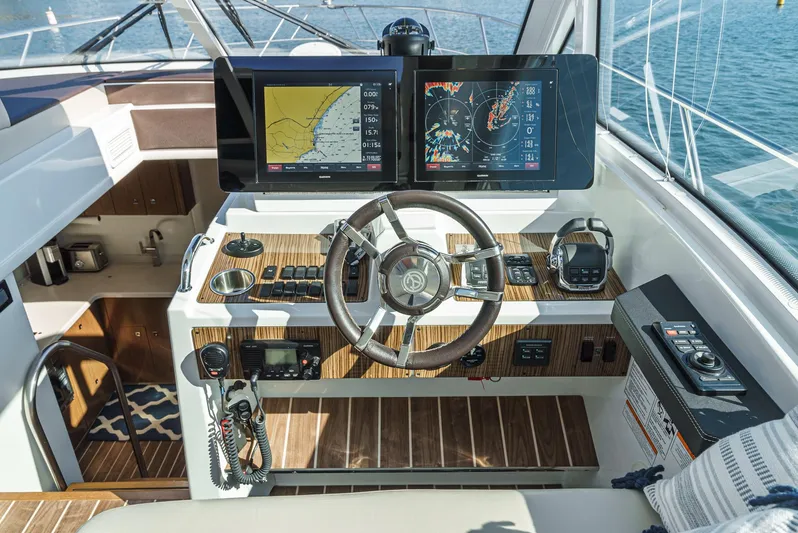 Serenity Yacht Photos Pics Helm of 2015 Cruisers Yachts 48 Cantius with advanced navigation displays and controls.