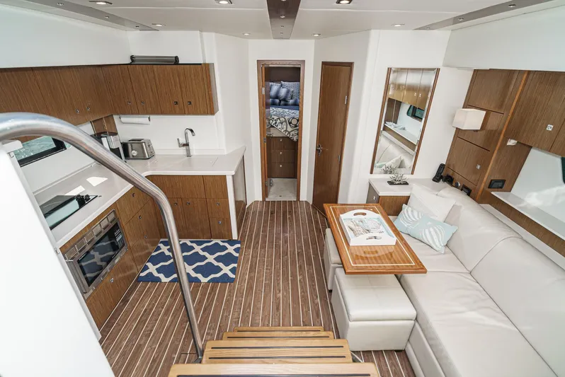Serenity Yacht Photos Pics Luxurious interior of 2015 Cruisers Yachts 48 Cantius with modern kitchen and seating area.