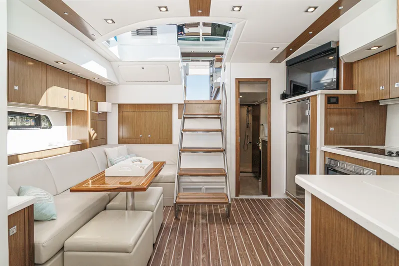 Serenity Yacht Photos Pics Luxurious interior of 2015 Cruisers Yachts 48 Cantius with modern kitchen and seating area.