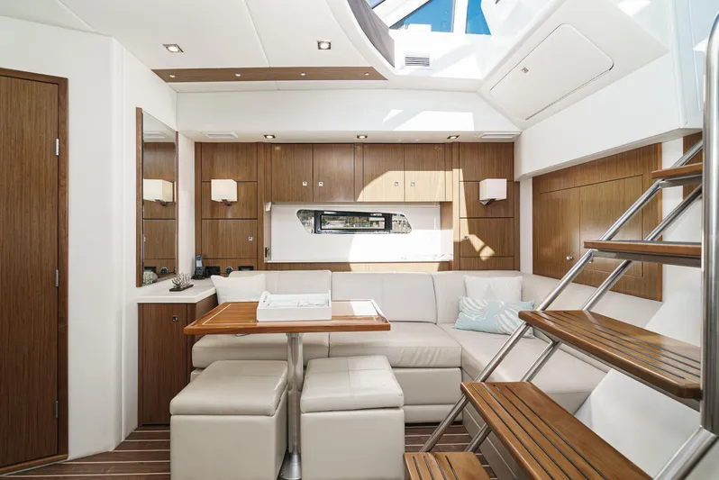 Serenity Yacht Photos Pics Luxurious interior of 2015 Cruisers Yachts 48 Cantius with modern seating and wooden accents.