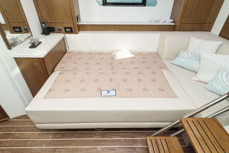 Serenity Yacht Photos Pics Luxurious interior of 2015 Cruisers Yachts 48 Cantius with elegant bedding and wooden accents.