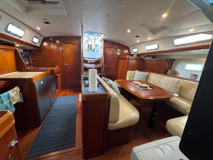 Liquid Sunshine Yacht Photos Pics Interior of 2005 Beneteau 523 Oceanis yacht with wood finishes and comfortable seating.