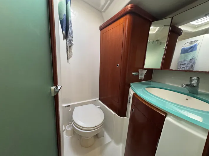 Liquid Sunshine Yacht Photos Pics Bathroom interior of 2005 Beneteau 523 Oceanis yacht with modern fixtures and wood cabinetry.