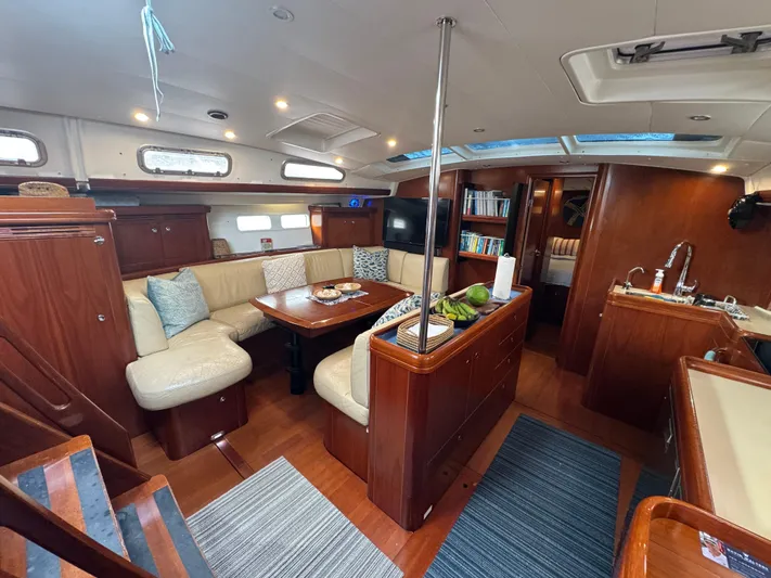 Liquid Sunshine Yacht Photos Pics Interior of 2005 Beneteau 523 Oceanis yacht with elegant wood finish and cozy seating area.