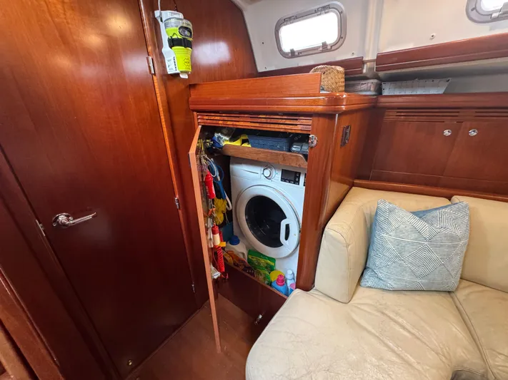 Liquid Sunshine Yacht Photos Pics Interior of 2005 Beneteau 523 Oceanis yacht with washing machine and cozy seating area.