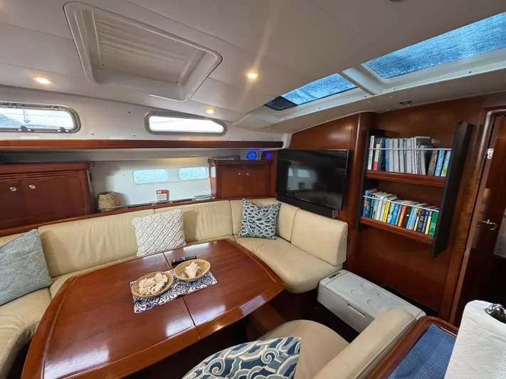 Liquid Sunshine Yacht Photos Pics Luxurious interior of 2005 Beneteau 523 Oceanis yacht with plush seating and wooden finishes.
