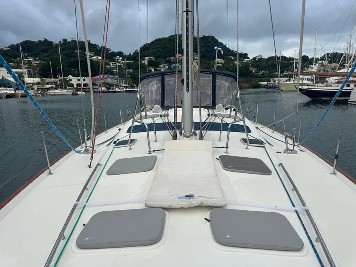 Liquid Sunshine Yacht Photos Pics 2005 Beneteau 523 Oceanis sailboat deck with marina and hills in background.