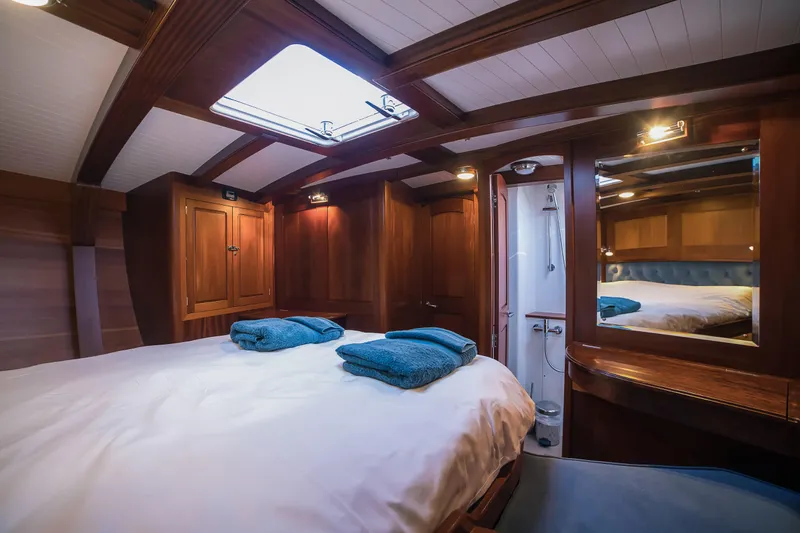 Spirit Of Galatea Yacht Photos Pics Luxurious 2014 Spirit Yachts cabin interior with wooden finish and cozy bedding.