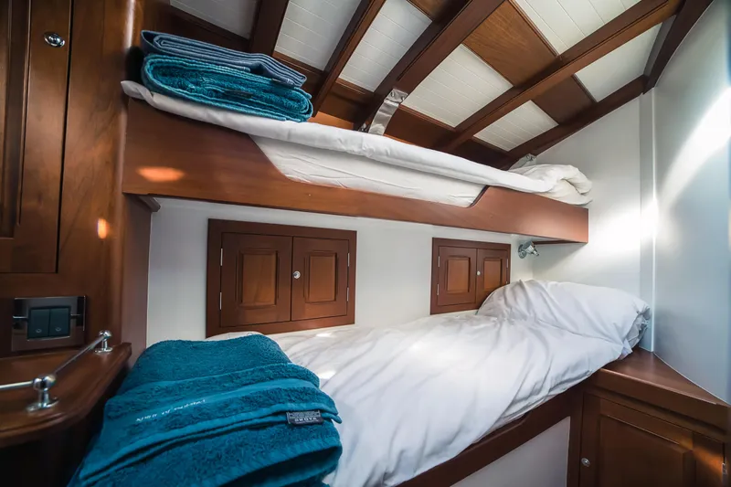 Spirit Of Galatea Yacht Photos Pics Luxurious 2014 Spirit Yachts cabin with wooden bunk beds and cozy linens.