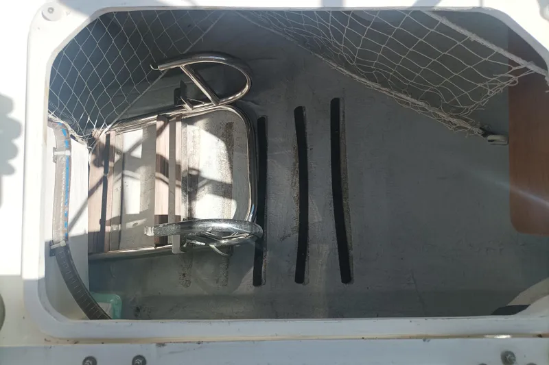 Ritual Yacht Photos Pics Storage compartment of a 2020 Beneteau First 53 yacht with netting and metal fixtures.