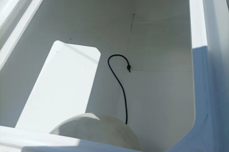 Ritual Yacht Photos Pics Storage compartment on 2020 Beneteau First 53 yacht, featuring a coiled cable.