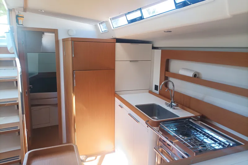 Ritual Yacht Photos Pics Interior of 2020 Beneteau First 53 yacht, featuring modern kitchen with wood accents.
