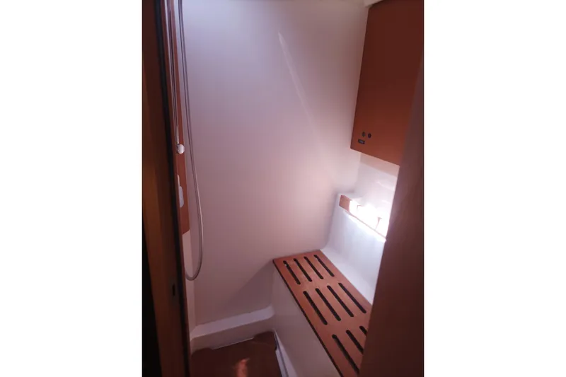 Ritual Yacht Photos Pics Interior shower area of 2020 Beneteau First 53 yacht, featuring sleek wooden accents.