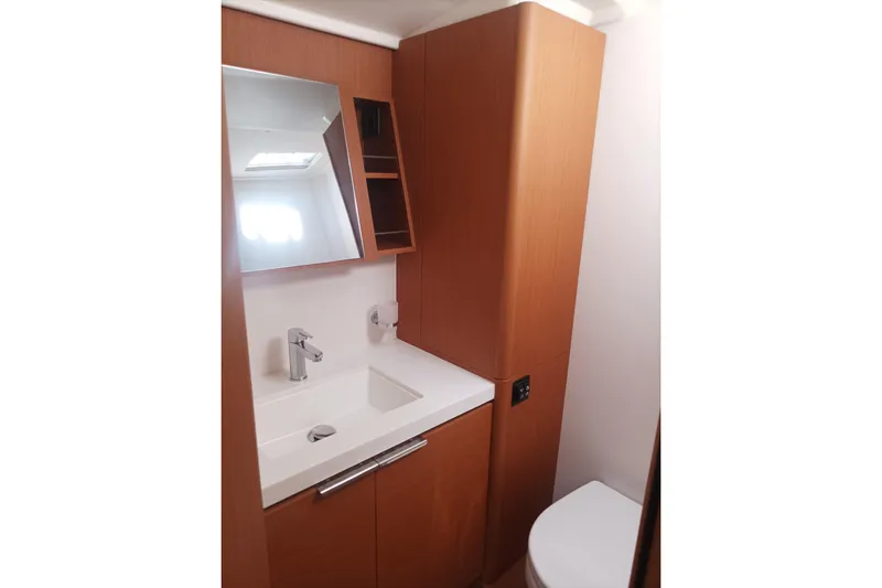 Ritual Yacht Photos Pics Modern bathroom interior on 2020 Beneteau First 53 yacht, featuring sleek wood cabinetry.