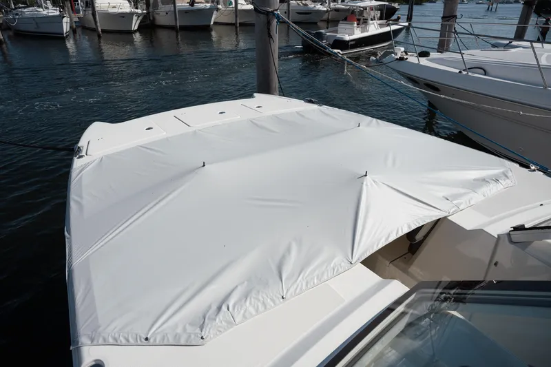  Yacht Photos Pics 2024 World Cat 400 DC-X boat with a white cover docked at a marina.