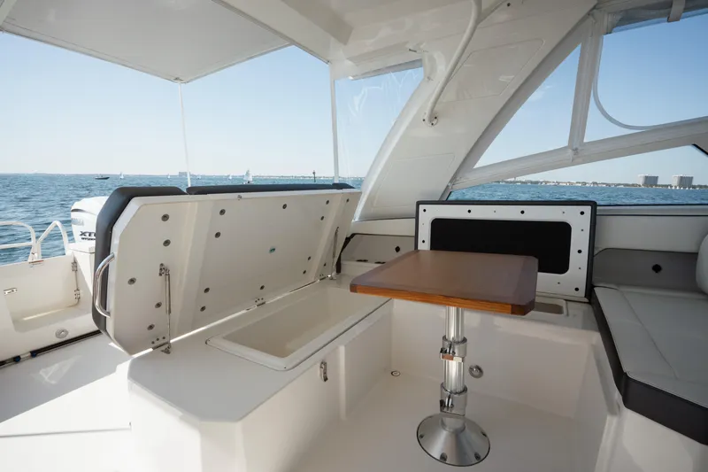  Yacht Photos Pics 2024 World Cat 400 DC-X boat interior with seating and table, ocean view.