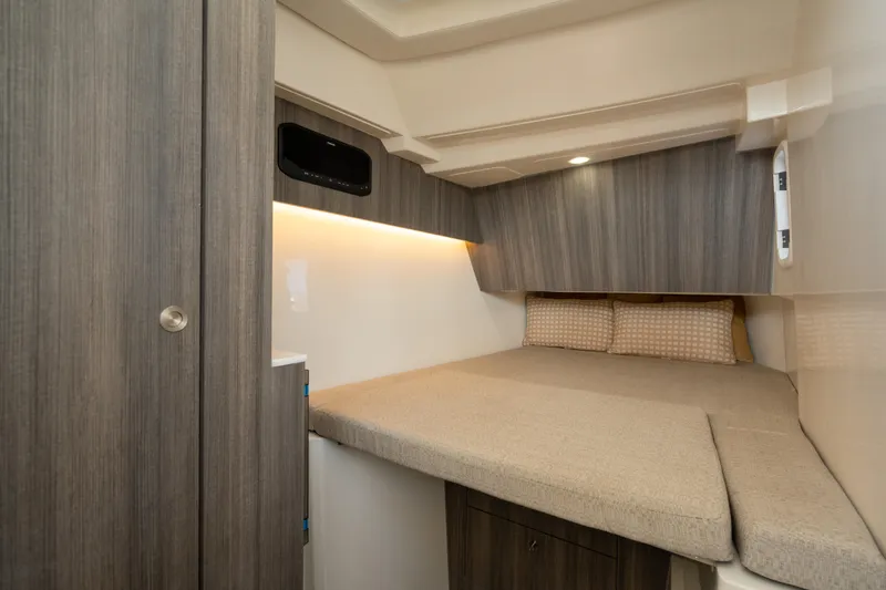  Yacht Photos Pics 2024 World Cat 400 DC-X cabin interior with cozy bed and modern wood paneling.