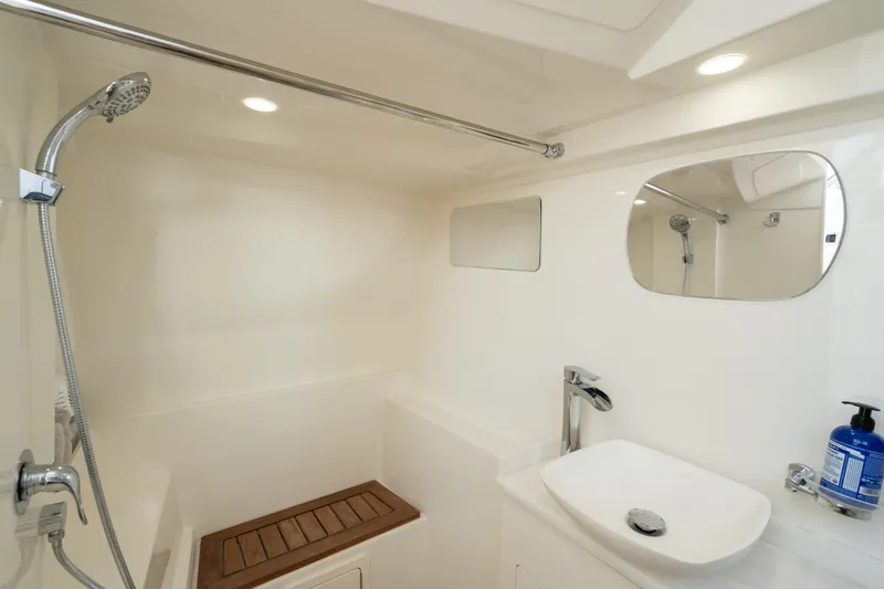  Yacht Photos Pics 2024 World Cat 400 DC-X boat bathroom with shower, sink, and mirror.