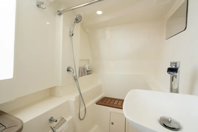  Yacht Photos Pics 2024 World Cat 400 DC-X boat bathroom with shower, sink, and modern fixtures.