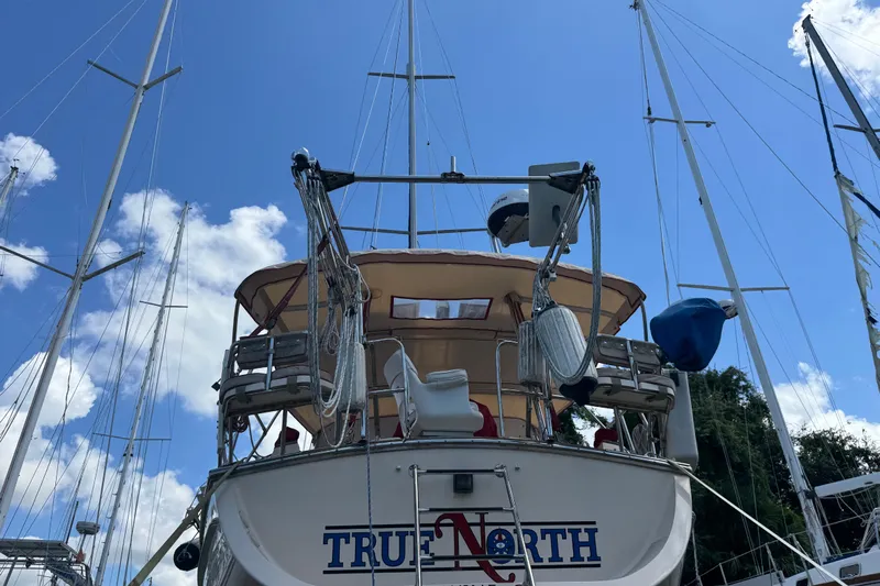True North Yacht Photos Pics 2004 Island Packet 420 sailboat docked under a clear blue sky.