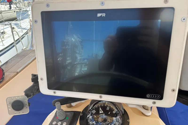 True North Yacht Photos Pics Navigation equipment on 2004 Island Packet 420 sailboat, featuring a compass and display screen.