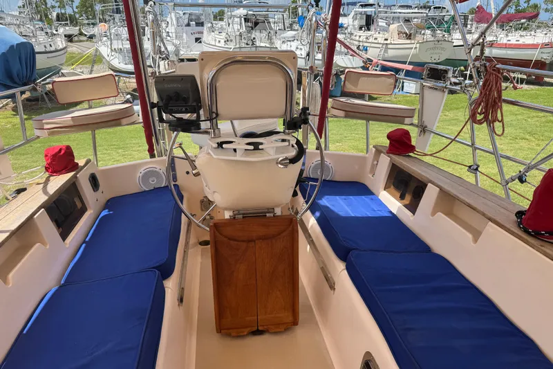 True North Yacht Photos Pics Cockpit of 2004 Island Packet 420 sailboat with blue cushions and steering wheel.