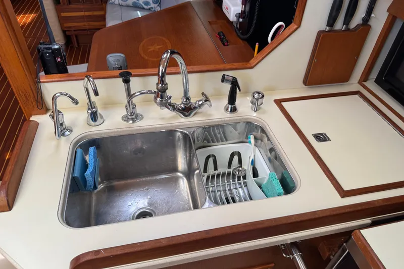 True North Yacht Photos Pics Galley sink in 2004 Island Packet 420 yacht with dish rack and sponges.